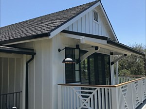 Black fascia with black round downspout